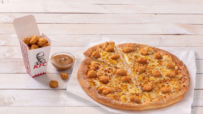 Pizza Hut and KFC have teamed up to release a 'Popcorn Chicken Pizza' with gravy dipping sauce